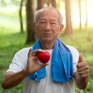 Photo of man holding a heart figurine