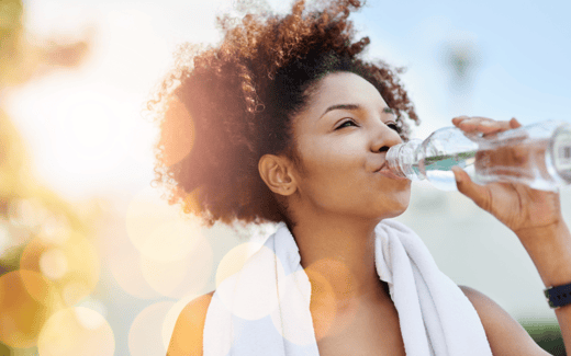 woman drinking bottled water