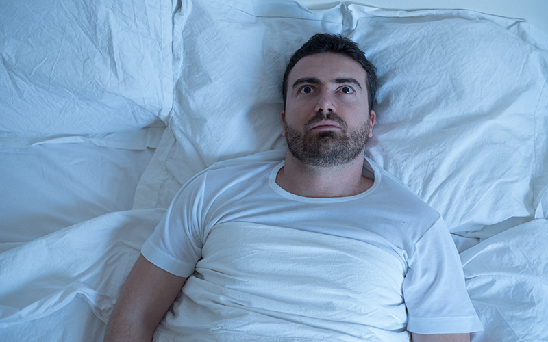 Stressed man in bed