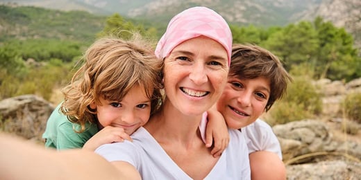 A woman taking a selfie with her two children
